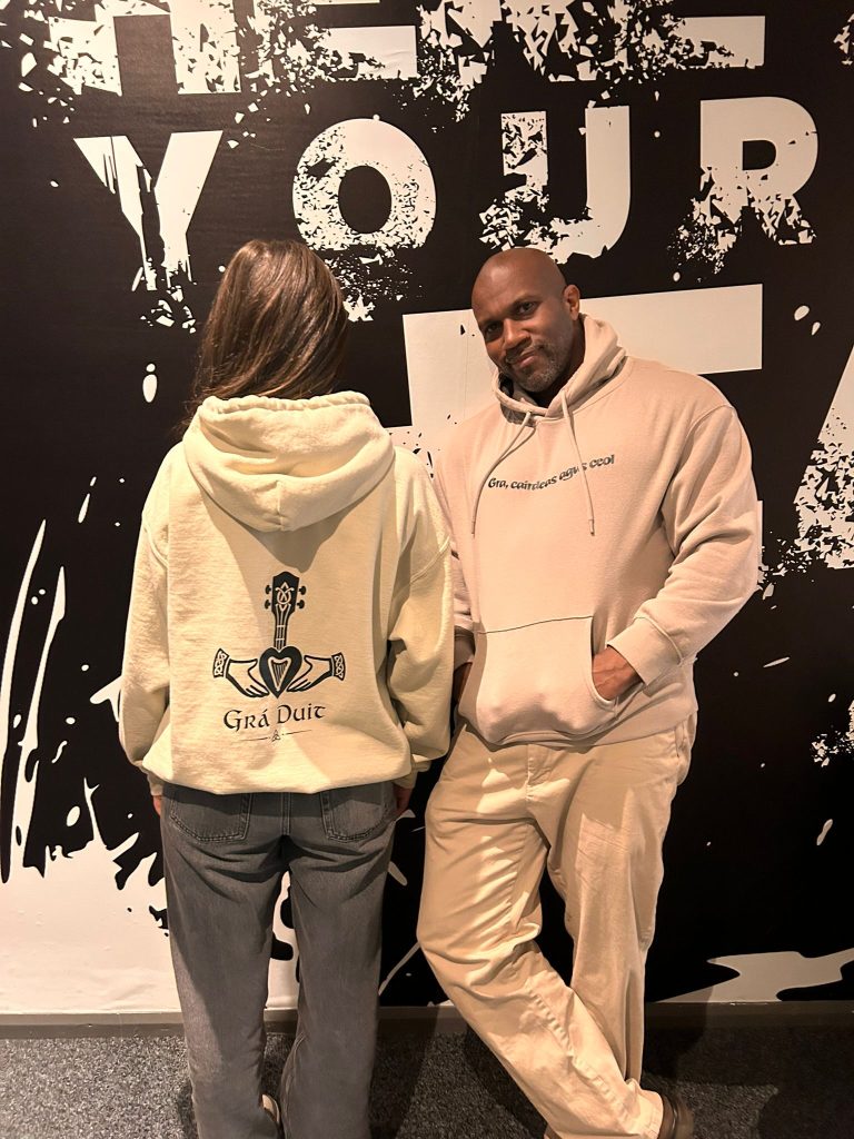 Grá Duit hoodie front and back launch wall shot